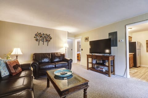 The living room features a large TV and cozy seating.