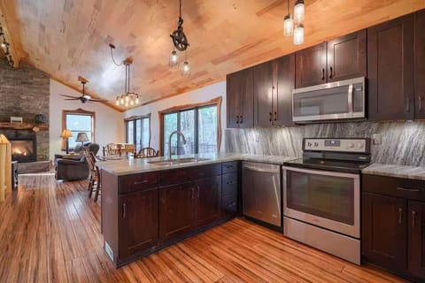 Open concept kitchen, dining, and living room with abundant natural light