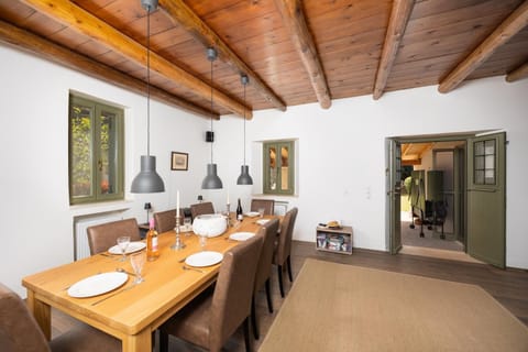 Main building: Living room with sofa, dining area, ornamental fireplace, and WiFi internet