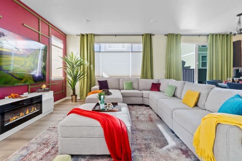 Welcoming living room featuring a cozy sectional sofa adorned with decorative pillows and throws, ideal for relaxation and comfort.