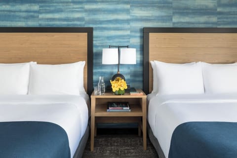 Wake up together in twin beds with cozy, modern styling.