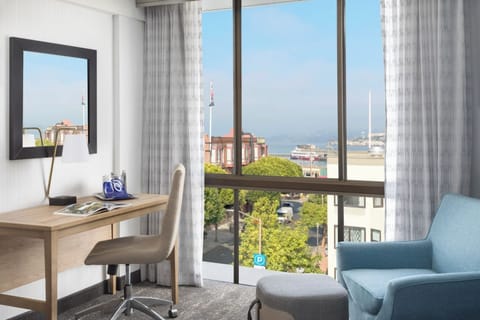 Catch up on emails at a sunlit desk with views.