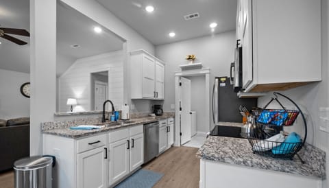 Pass through kitchen to laundry room & back door to patio. 