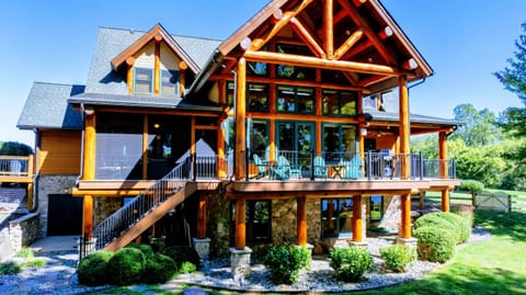 Experience the charm of this luxurious log cabin with stunning architecture, spacious balconies, and breathtaking views of the surrounding nature.