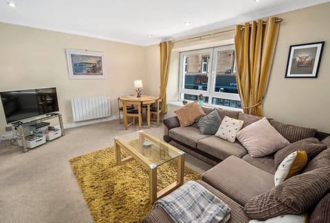 Living area with ample natural lighting and comfortable seating