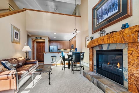 Stunning living room with a large fireplace and a view and open floor plan