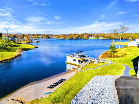 Beautiful private beach with lounge chairs, a slide, and a nearby dock overlooking a peaceful lake, ideal for a family-friendly getaway.