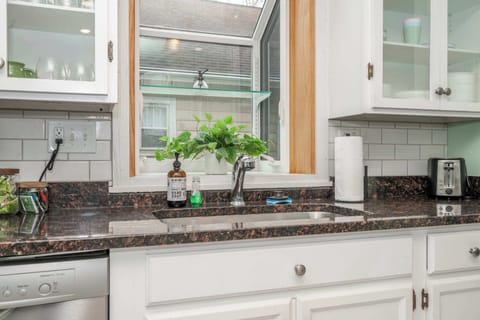 The bright, airy kitchen offers ample space & all the comforts of home