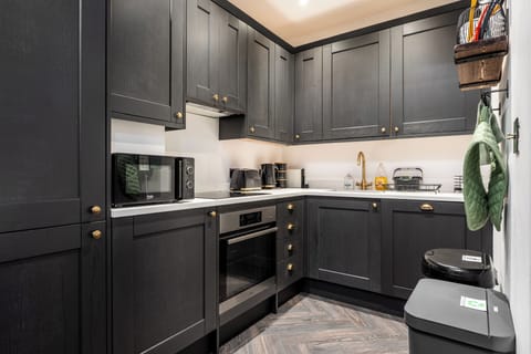 Imagine cooking in this modern kitchen equipped with a premium coffee machine, built-in dishwasher, and integrated washing machine. Complete with full sets of cutlery, plates, bowls, and every amenity you need to cook and entertain.