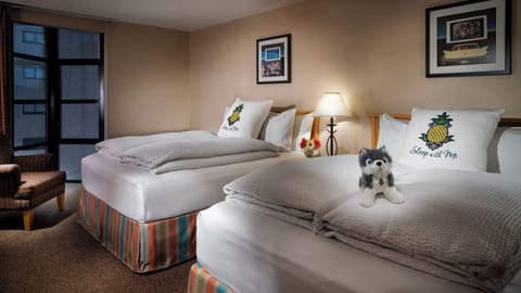 Unwind in bright twin beds with cozy lounge corner.