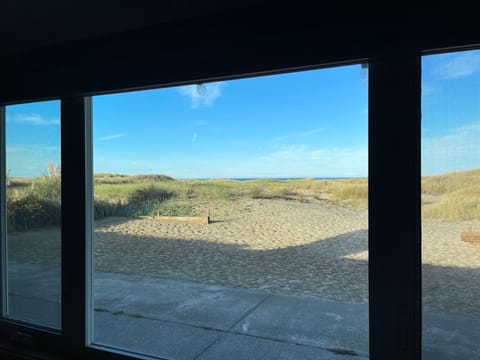 View of patio from living room. Beach and ocean right out the back door.
