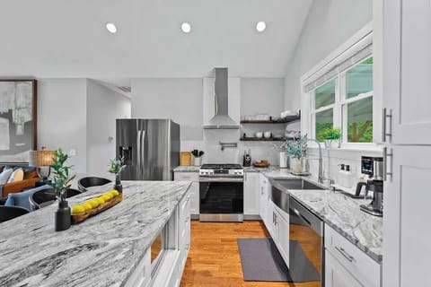 Modern kitchen with spacious island, natural light, and mountain views.