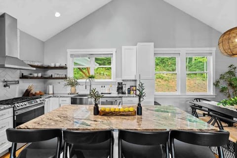 Our kitchen is designed for both cooking and gathering, featuring a spacious island, modern appliances, and abundant natural light. Enjoy glimpses of the mountains while preparing meals in this stylish and functional space.