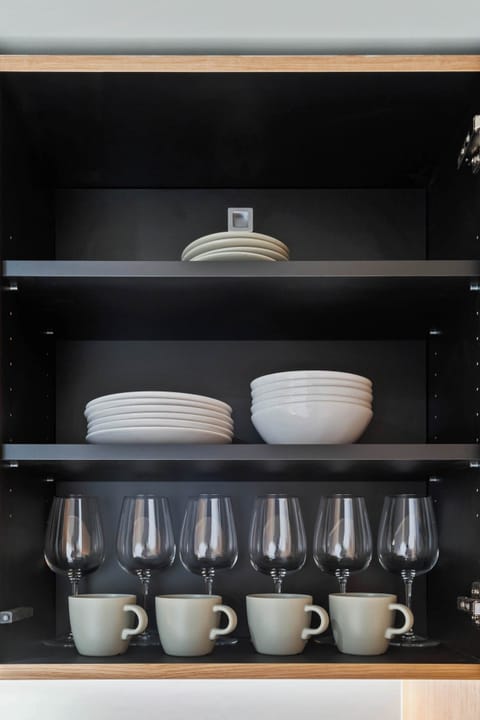 Kitchen Essentials – Neatly organized cabinets stocked with plates, cups, and other essentials for your stay.