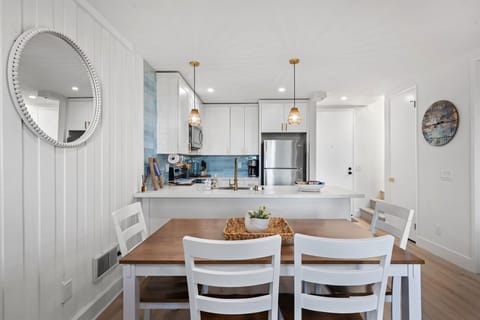 The charming wooden dining table comfortably seats 6, offering a cozy space for shared meals and conversations