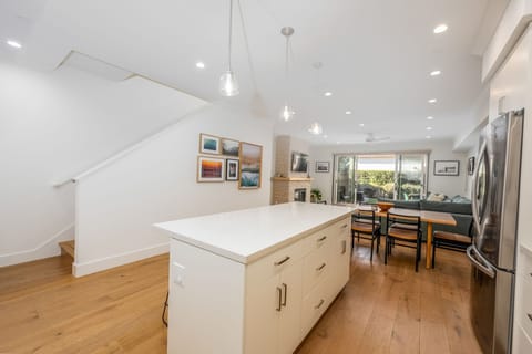 The first floor has tons of overhead recessed lighting with a dimmer switch as well as pendant lights over the island to create a bright and inviting atmosphere.
