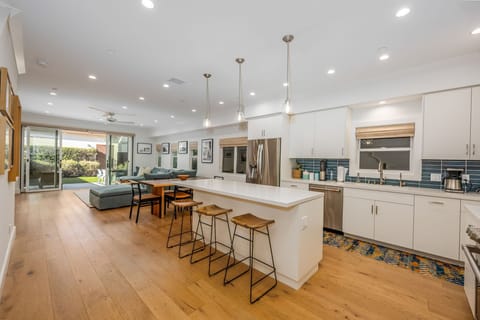 The open concept first floor provides a seamless transition from the kitchen to the dining table to the family room and finally to the back patio and garage.