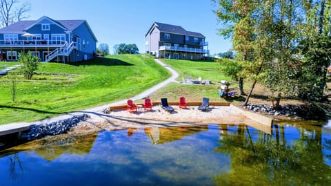 A private sandy beach with lounge chairs and a clear view of the lake, perfect for relaxing and enjoying the outdoors.