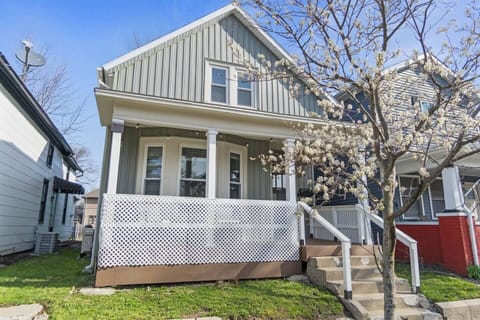 The front of the house featuring a cozy porch, situated in the vibrant downtown area of Fort Wayne.