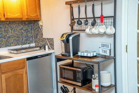 Fridge, microwave, coffee/tea maker, cookware/dishes/utensils