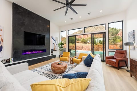 Great Room with plenty of seating, 65" Smart TV and a fireplace.