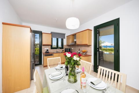 Open-plan living room with sofas, dining area, kitchen, ornamental fireplace, A/C, WiFi internet, satellite TV, and sea views