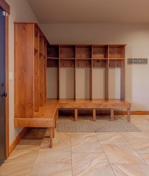 The mudroom offers ample cubbies, ideal for storing and organizing outdoor gear.