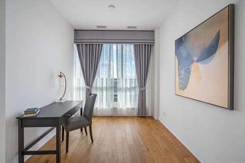 Dedicated office space with a desk, chair, lamp and plenty of natural light.