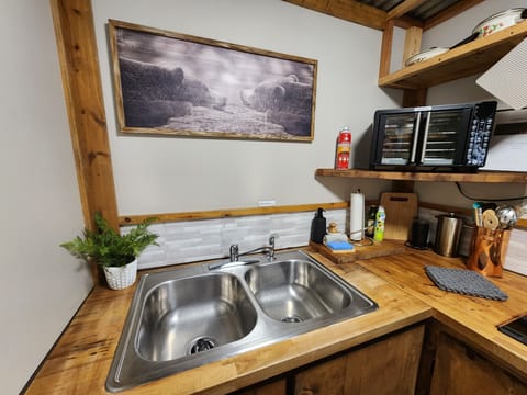 Coffee grinder, french press and tea pot provided.