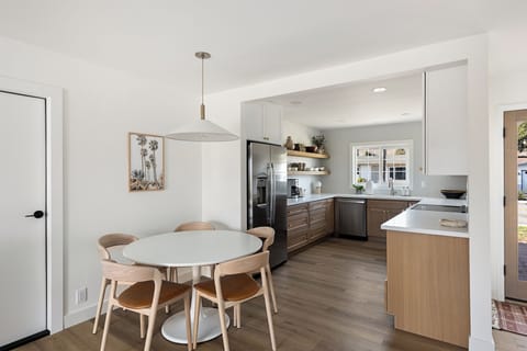 Dinning table with 6th chair at desk to use as needed.