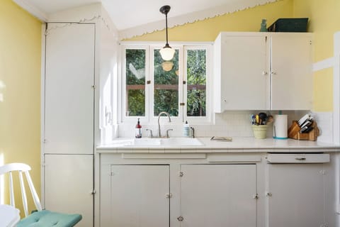 A cheery yellow and white kitchen with modern touches.