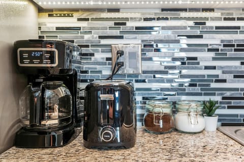 The coffee station is thoughtfully equipped with a variety of in-house consumables, including a selection of ground coffee, sweeteners, and creamers to suit every taste.