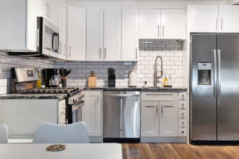 Cook with ease in this well-equipped kitchen featuring stainless steel appliances, ample cabinetry, and a stylish backsplash. Whether you're brewing coffee or preparing a gourmet meal, this space is designed for functionality and style, making every meal