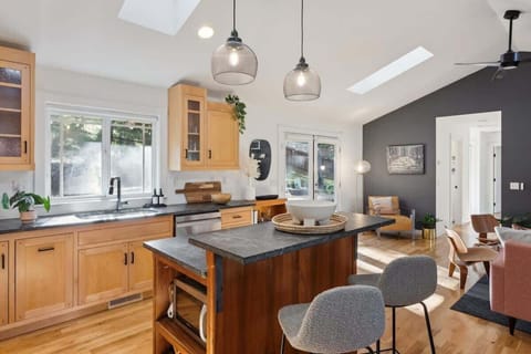 A beautifully designed kitchen with contemporary lighting and inviting open-concept living.