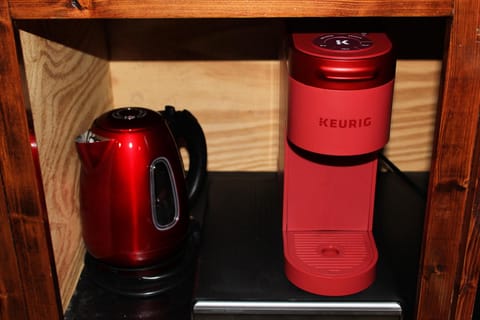 Vintage hot water kettle and Keurig with k-cups in the drawer below 