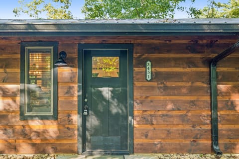 Inviting cabin entrance with warm lighting and rustic wood charm.