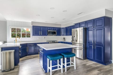 Our fully equipped, modern kitchen, featuring a spacious island and vibrant blue cabinetry.