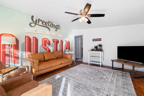 Front House: Relax in a Cozy Living Room with an Austin Mural