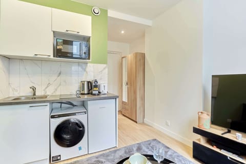 Pièce principale avec canapé lit, TV et cuisine