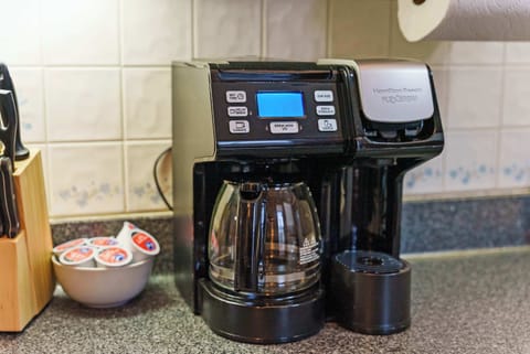 The airy kitchen offers ample space & every home comfort