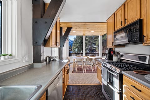The kitchen features a gas range, double oven and generous prep space.