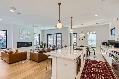 Spacious kitchen with a large island and seating, ideal for enjoying morning coffee or group meal prep.