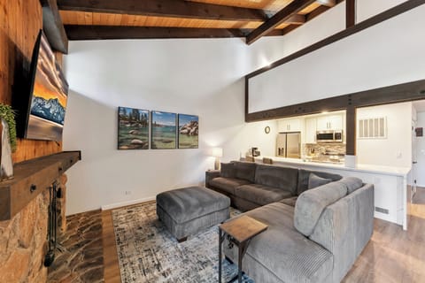 The loft overlooks the living room from the vaulted ceilings