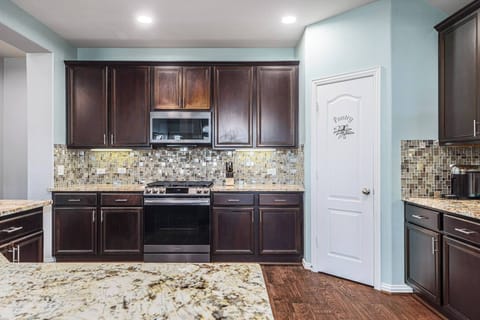 The kitchen is spacious and stocked with the essentials you need for cooking.