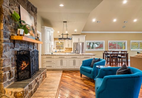 A cozy living area anchored by a stone fireplace, providing a warm and inviting spot for conversations, game nights, or simply curling up with a good book.
