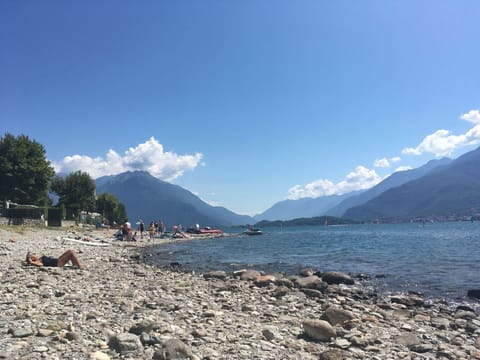 Sky, Water, Mountainous Landforms, Mountain, Body Of Water, Coast, Coastal And Oceanic Landforms, Beach, Hill, Sea