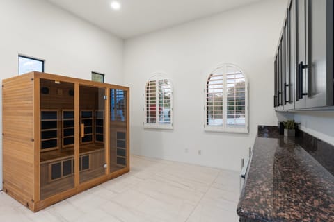 2 person infrared sauna and bar area with beverage fridge