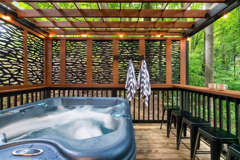 Relax in the Hot Tub with a View of the Peaceful Surrounding Forest.