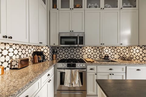 cupboards full of dishes, glasses, pots, pans, baking sheet, silver wear, etc.