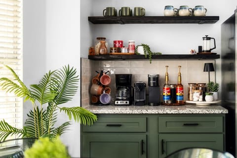 Start your day right with this charming coffee bar, fully stocked with coffee essentials, cozy mugs, and a stylish setup for the perfect morning brew!
